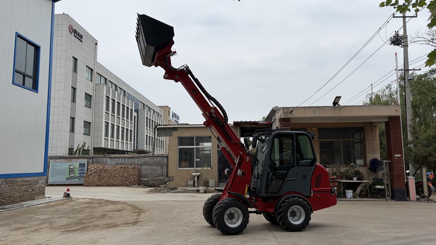 MCM DY35T telescopic boom extended lifting a bucket to height