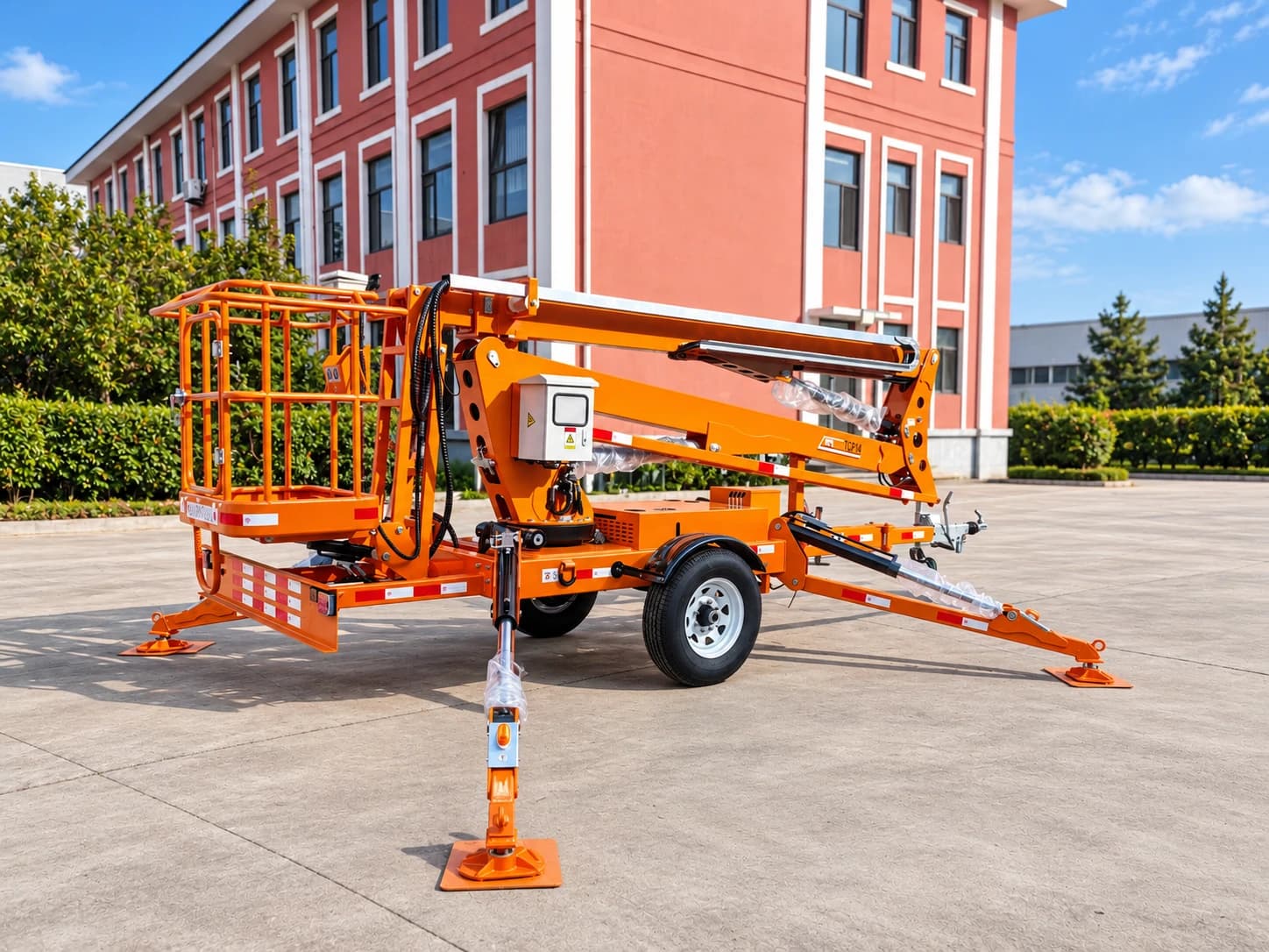 MCM TCP14 Cherry Picker / Trailer-Mounted Towable Boom Lift, three-quarter view with the boom folded and outriggers down
