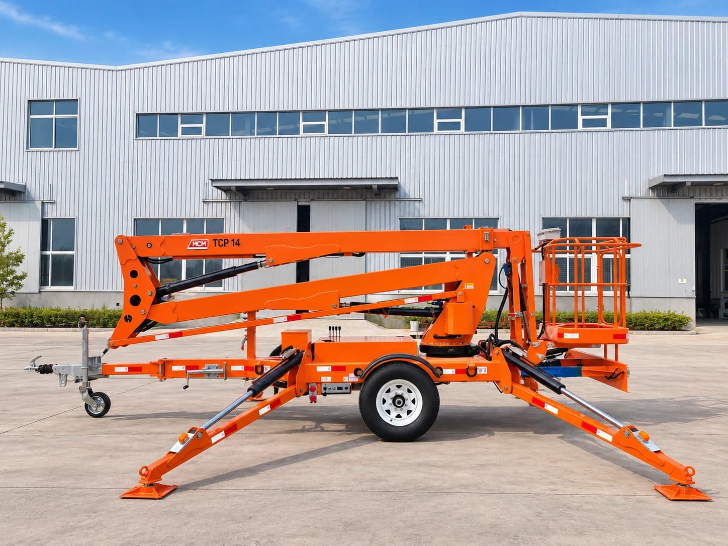 MCM TCP14 Cherry Picker / Trailer-Mounted Towable Boom Lift, side view with the boom folded and outriggers down