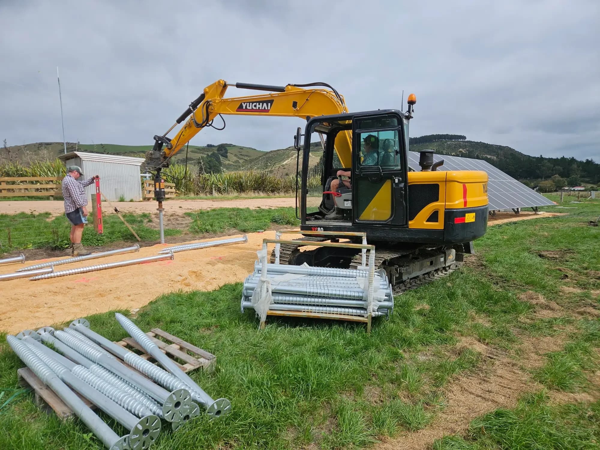 Yuchai YC80 excavator with auger drive installing ground screw piles