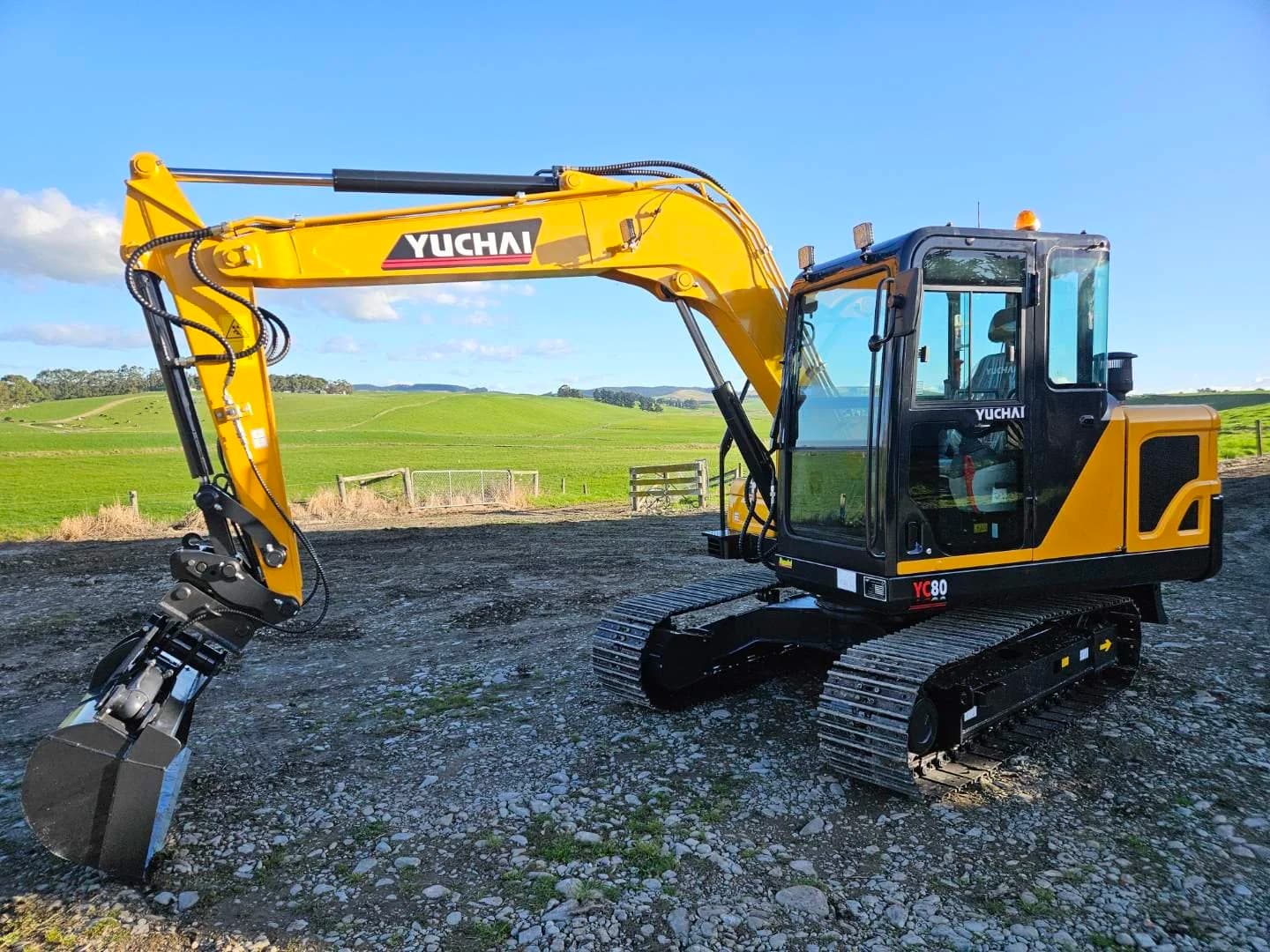 Yuchai YC80 excavator with quick hitch and bucket on a farm
