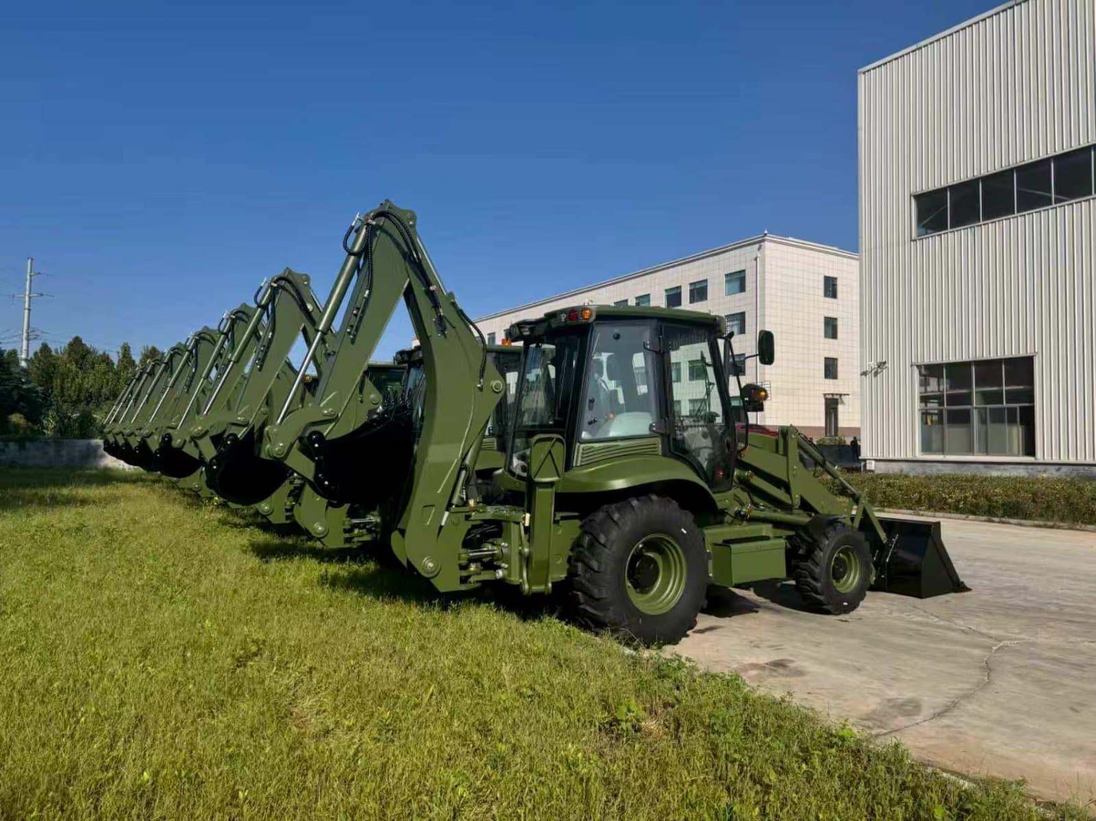 Row of MCM 388 TLB backhoe loaders with front loader buckets