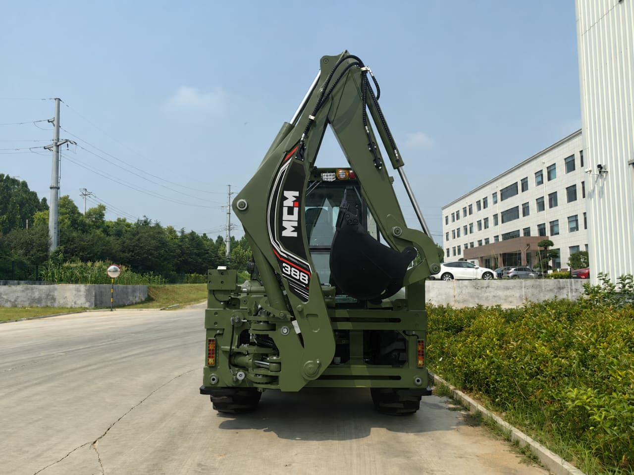 Rear view of the MCM 388 TLB backhoe arm and bucket