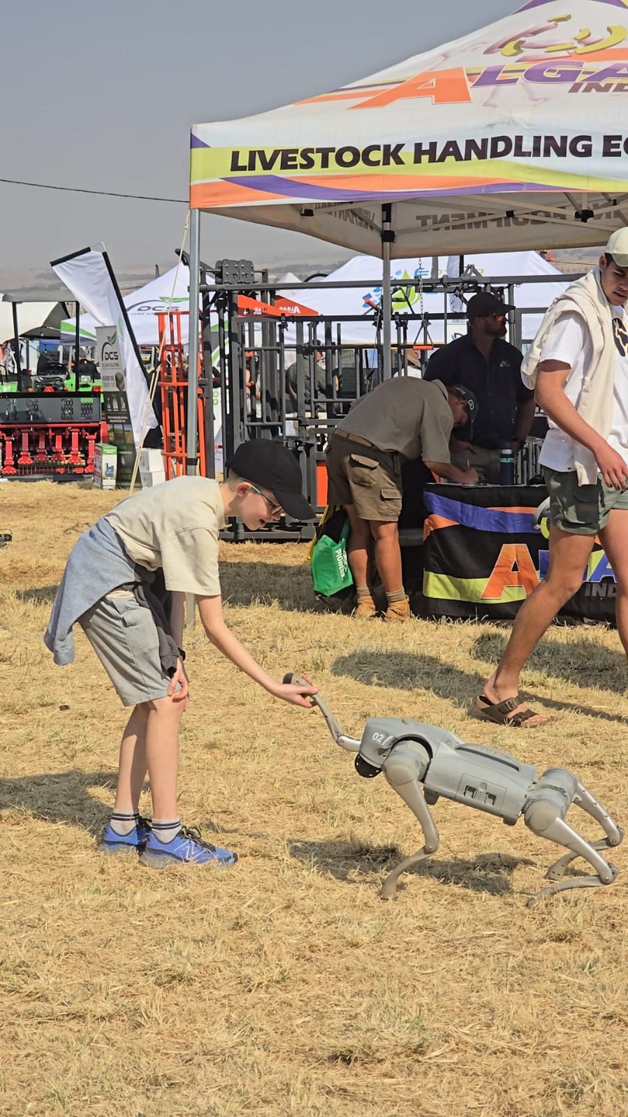 A young visitor walking alongside the Unitree Go2 robot at the MCM KragDag 2026 stand