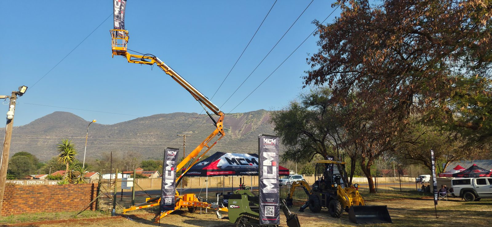 MCM TCP cherry picker boom raised above the MCM-branded stand at the 2026 Thabazimbi Skou