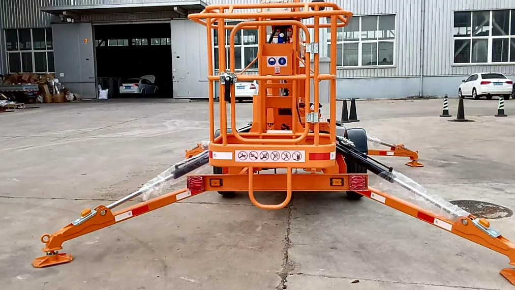 Rear view of an MCM towable cherry picker standing on its four hydraulic outriggers