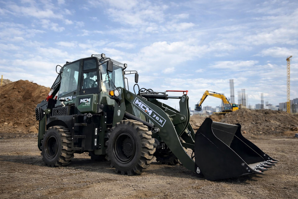TLB backhoe loader driving on road showing superior mobility over excavator South Africa