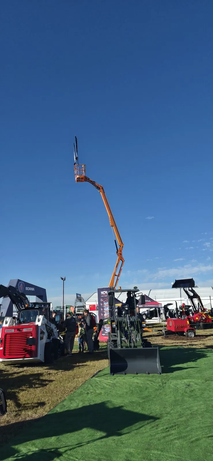 MCM towable cherry picker boom lift reaching skyward at the expo